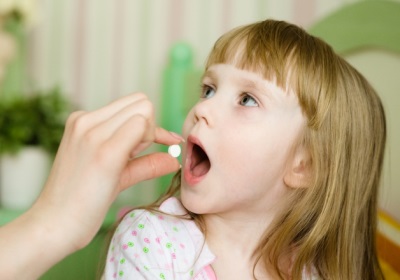 Girl drinking antibiotics