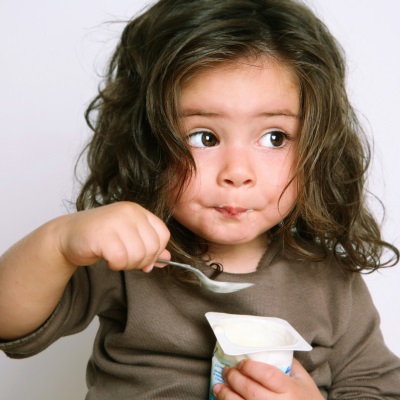 Girl eating prebiotic yogurt