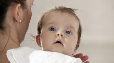 Baby in my mother's arms with a column