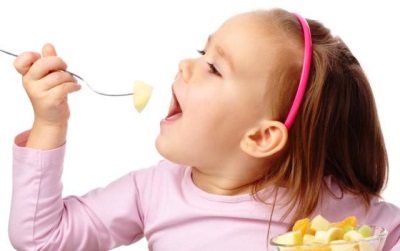 Child eating fruit salad