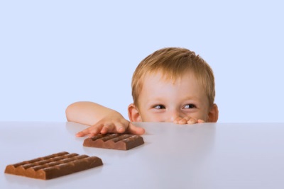 The child reaches for chocolate