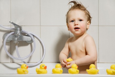 Baby with toys in the bath