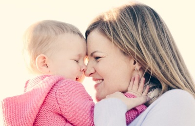 Baby 8 months mom in her arms