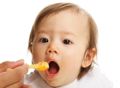 Baby eating yolk