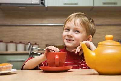 Baby at the table with tea