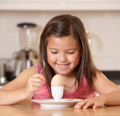 Baby eating a hard-boiled egg