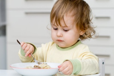 Baby eating fish