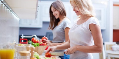 Mom cooks with her teenager daughter