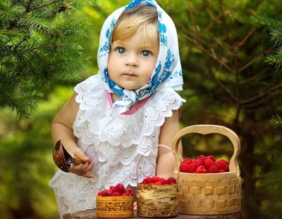 Baby with raspberries in baskets