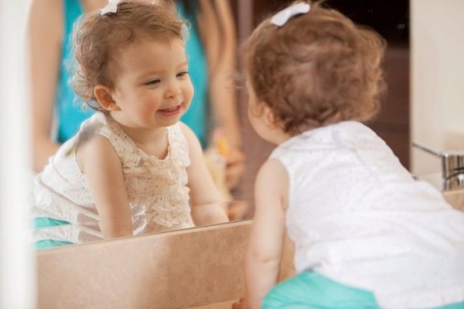 Baby 1 year old at the mirror