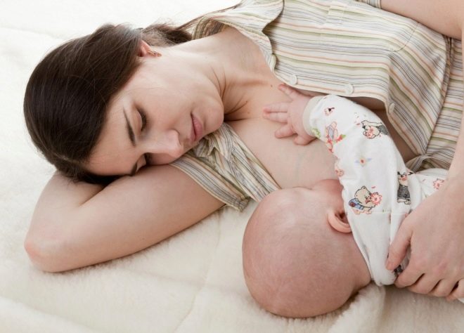 Baby eats breast milk from the breast